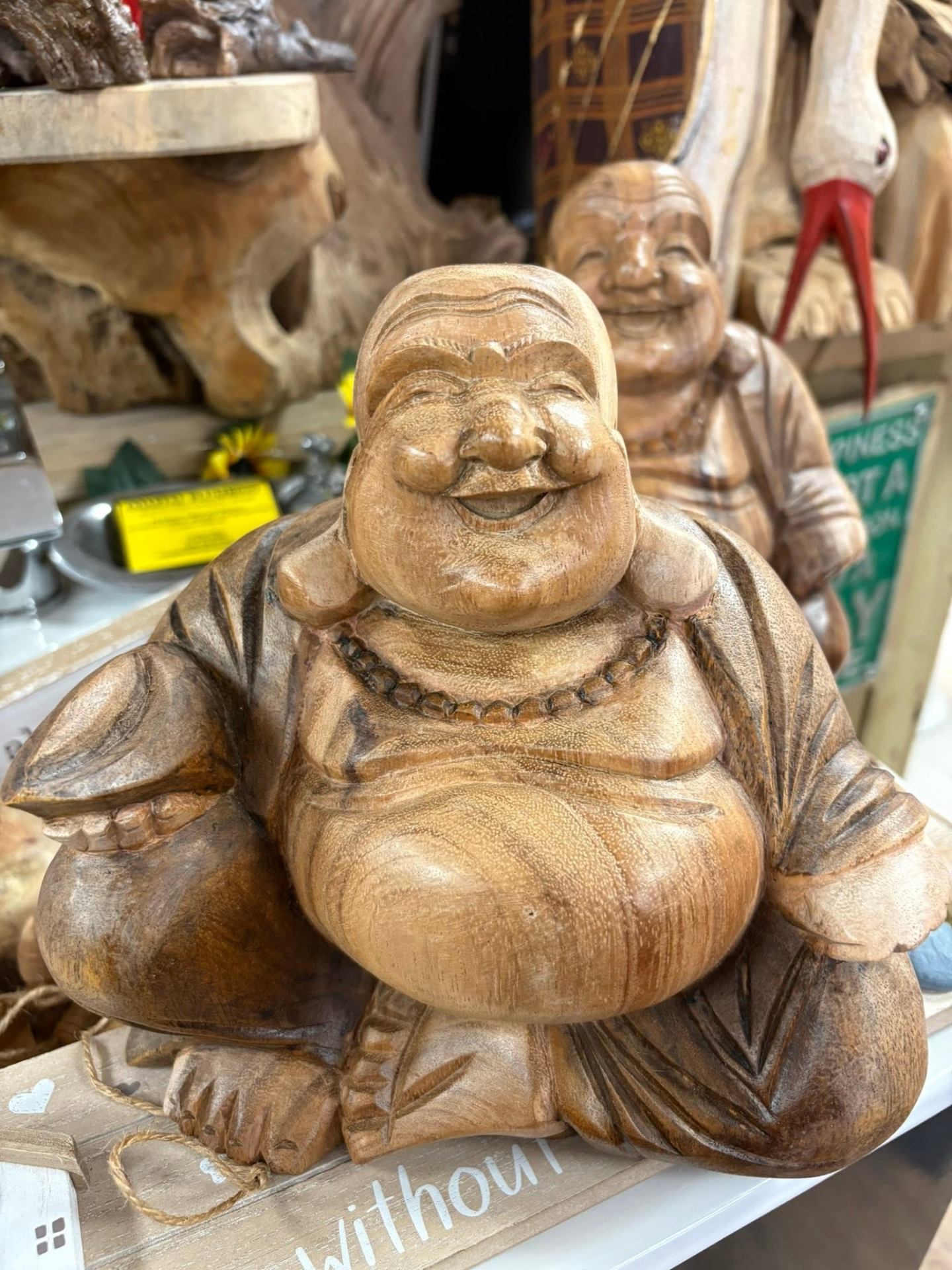Hand-carved wooden laughing Buddha statue